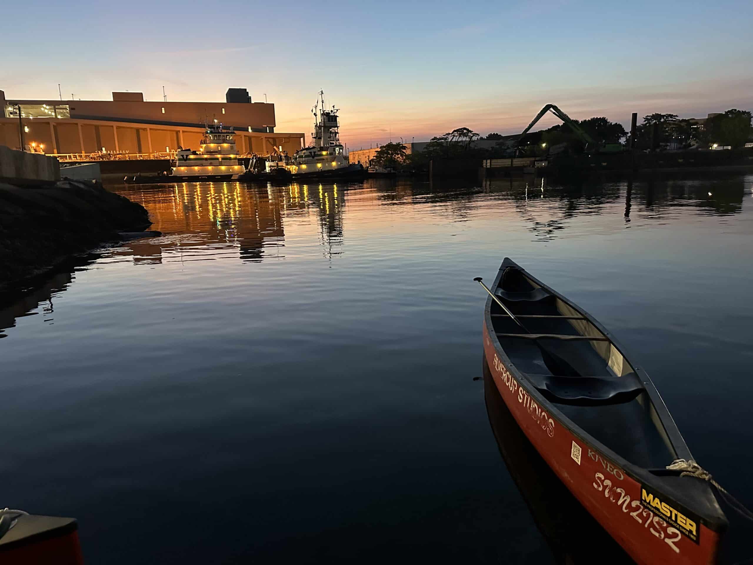 gowanus canal - a canoe on the water at dusk