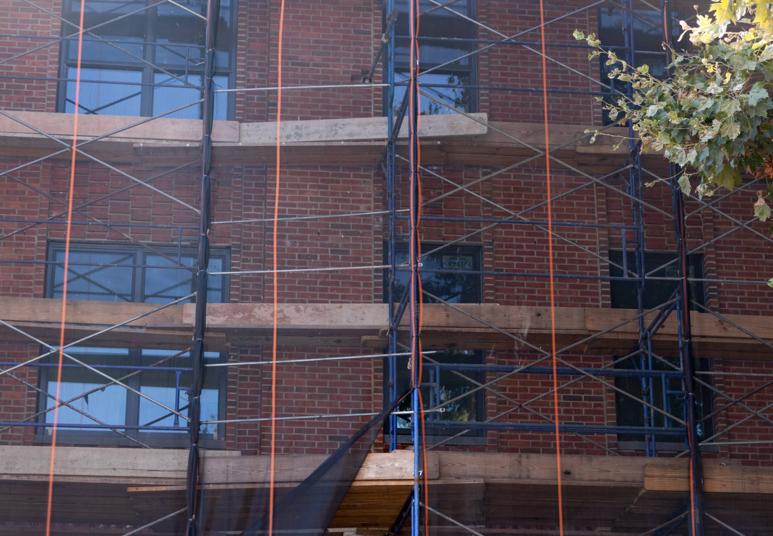 view under netting showing brick pattern of new building
