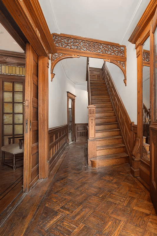 entry with fretwork, mirror and pocket doors to parlor