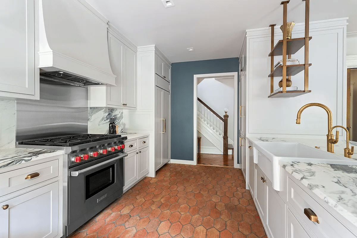 kitchen with white cabinets, an apron front sink and marble counters