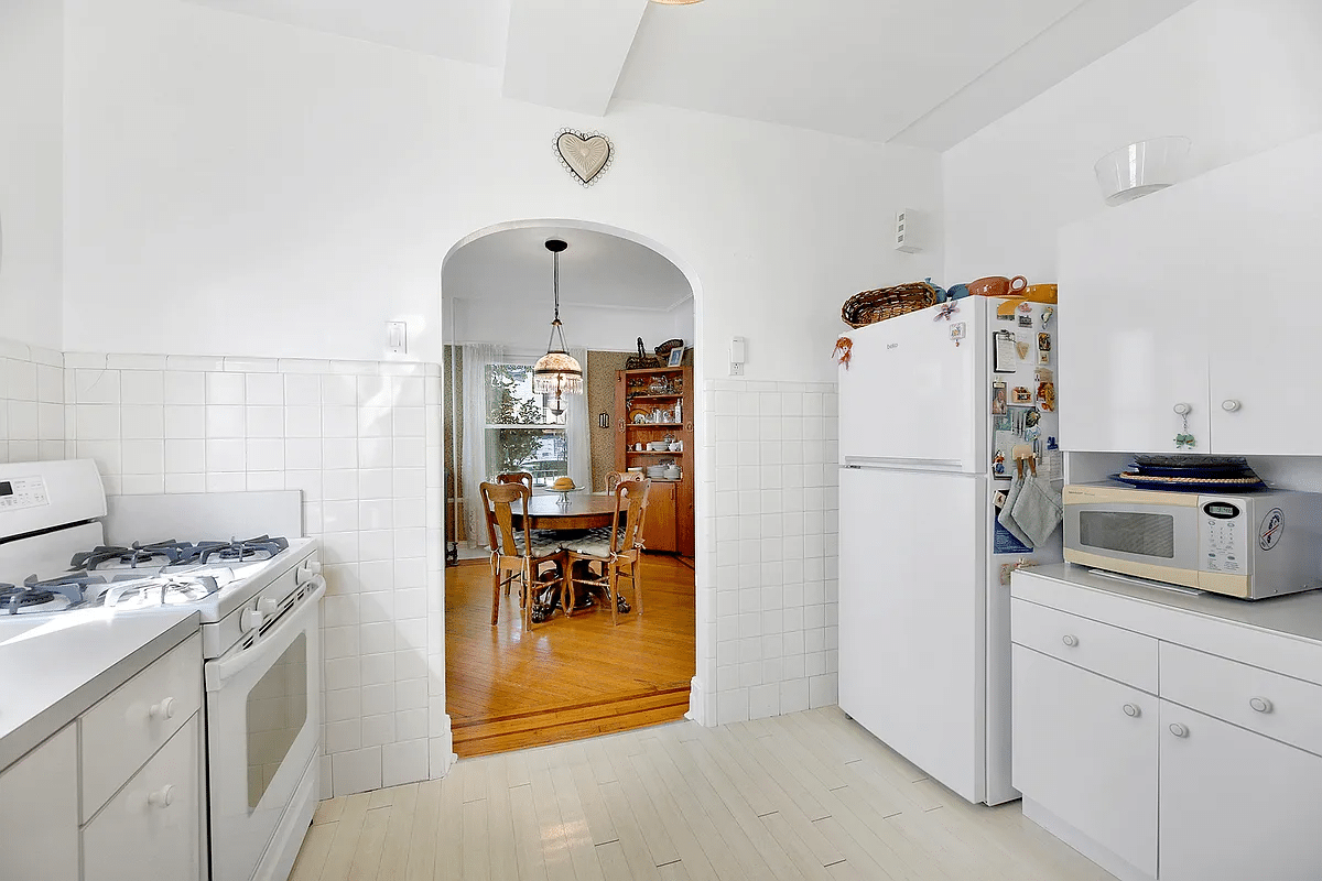 kitchen with arched entry to dining room