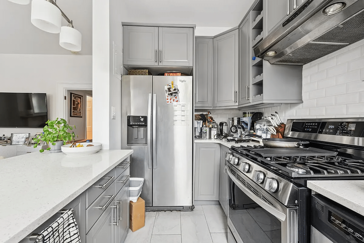 kitchen with gray cabinets, stainless steel appliances including a dishwasher