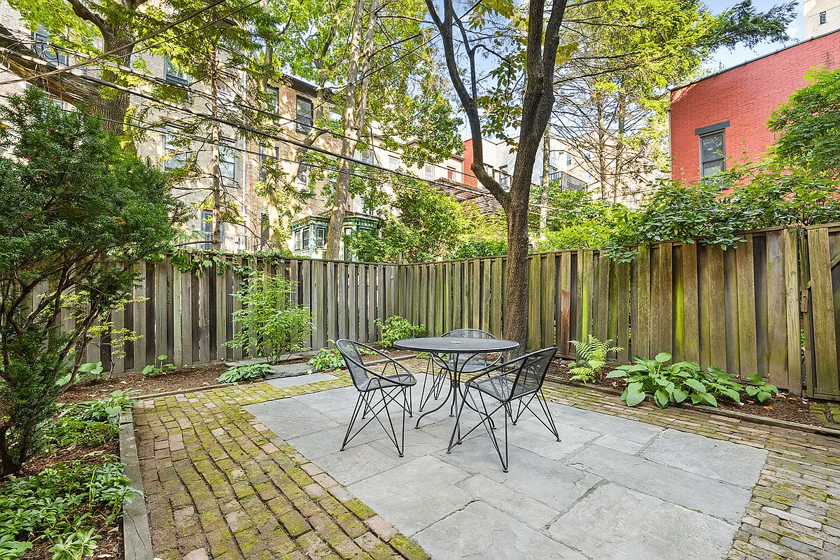 rear yard with a brick and stone patio