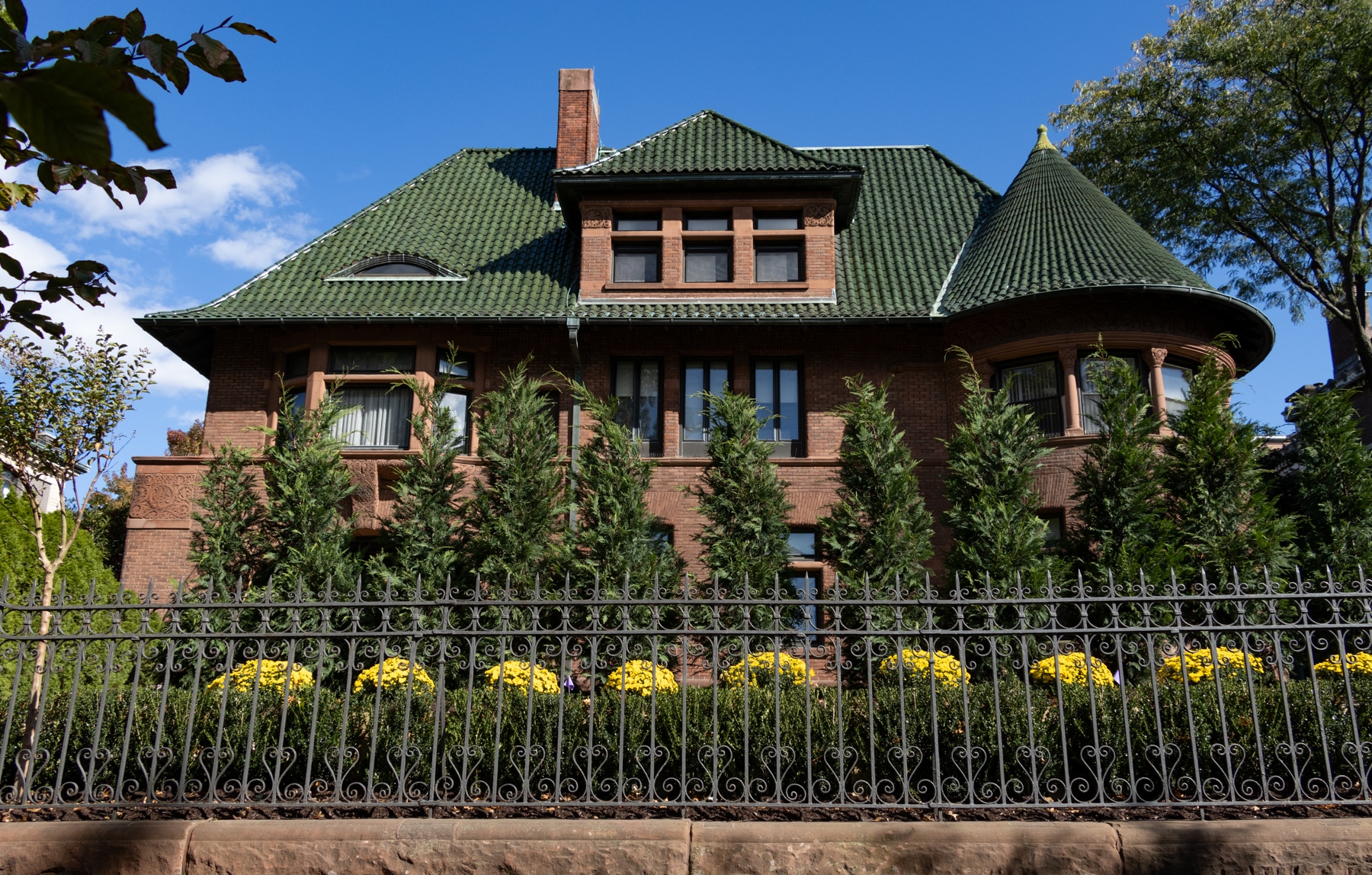 Brooklyn - yellow mums outside a clinton avenue mansion