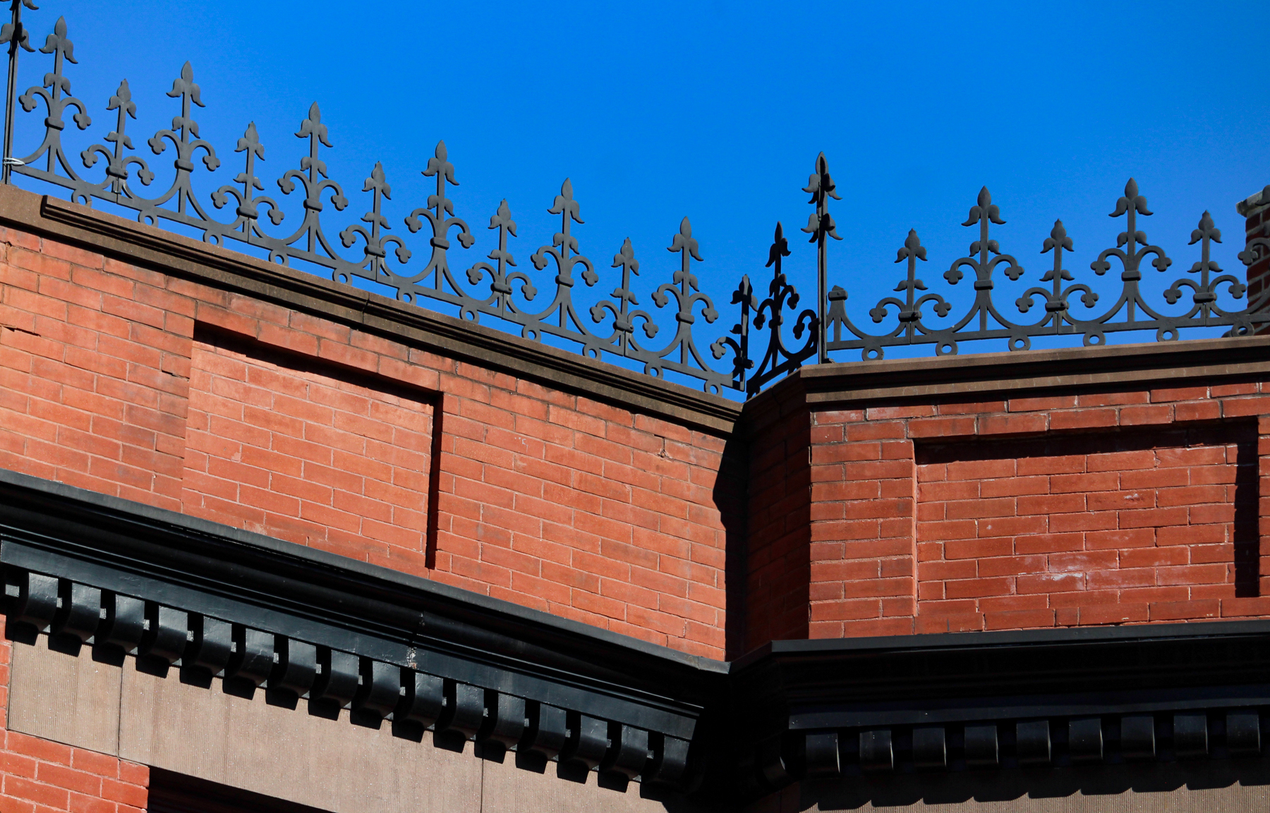 brooklyn - iron cresting on the top of a brick building in cobble hill
