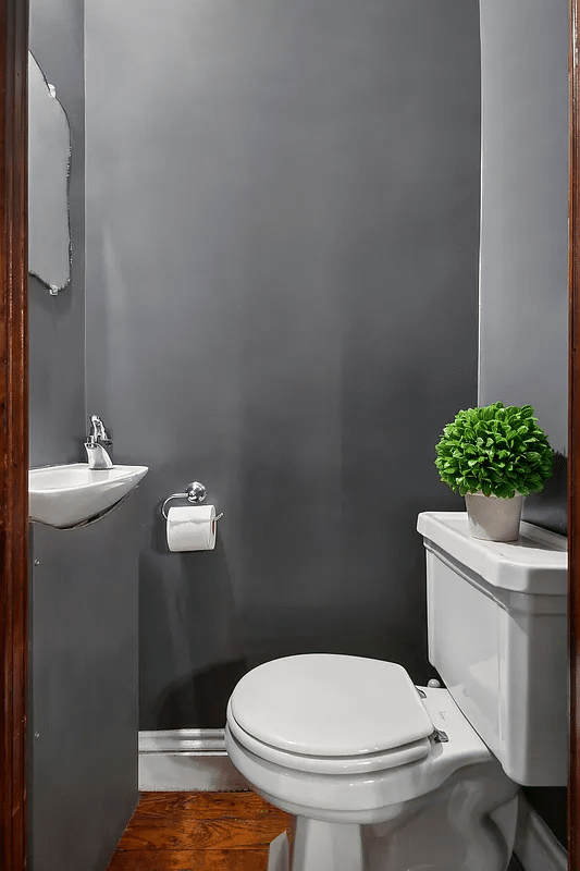 powder room with gray walls, petite white sink