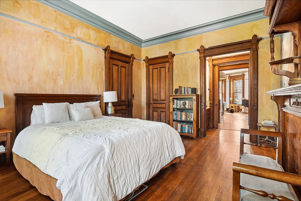 bedroom with moldings, wood floor, picture rail