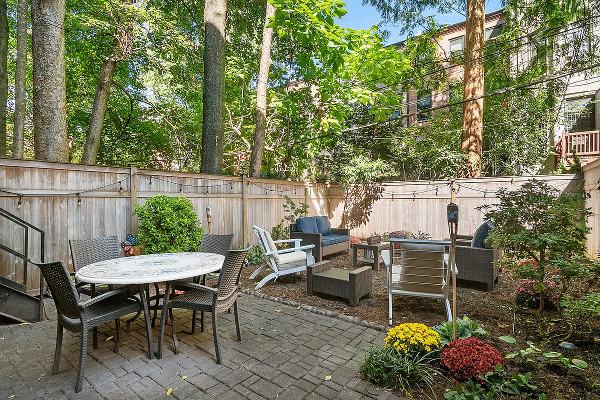rear yard with paved patio and a mulched seating area