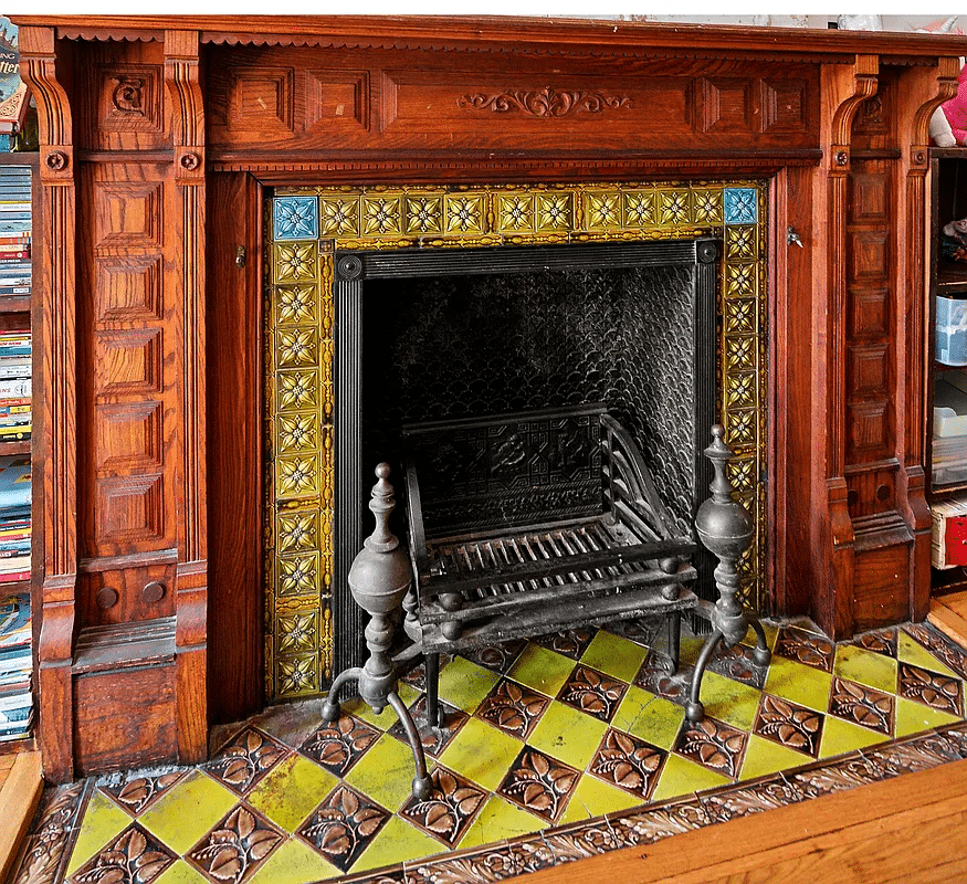 wood mantel with green, brown and blue tiles