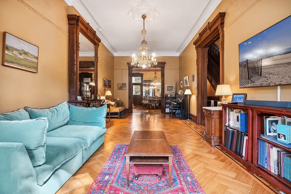 parlor with high ceiling, wood floor, mirror, and ceiling medallion