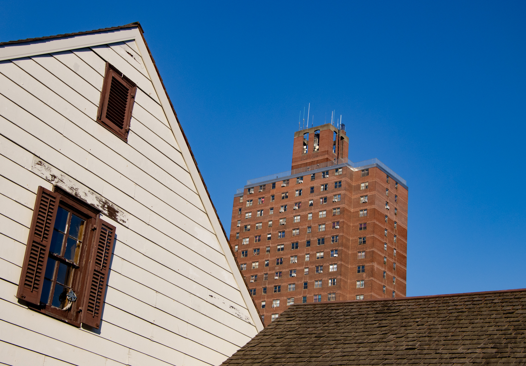 crown heights - a 19th century wood frame house with a view of the 20th century kingsborough houses beyond