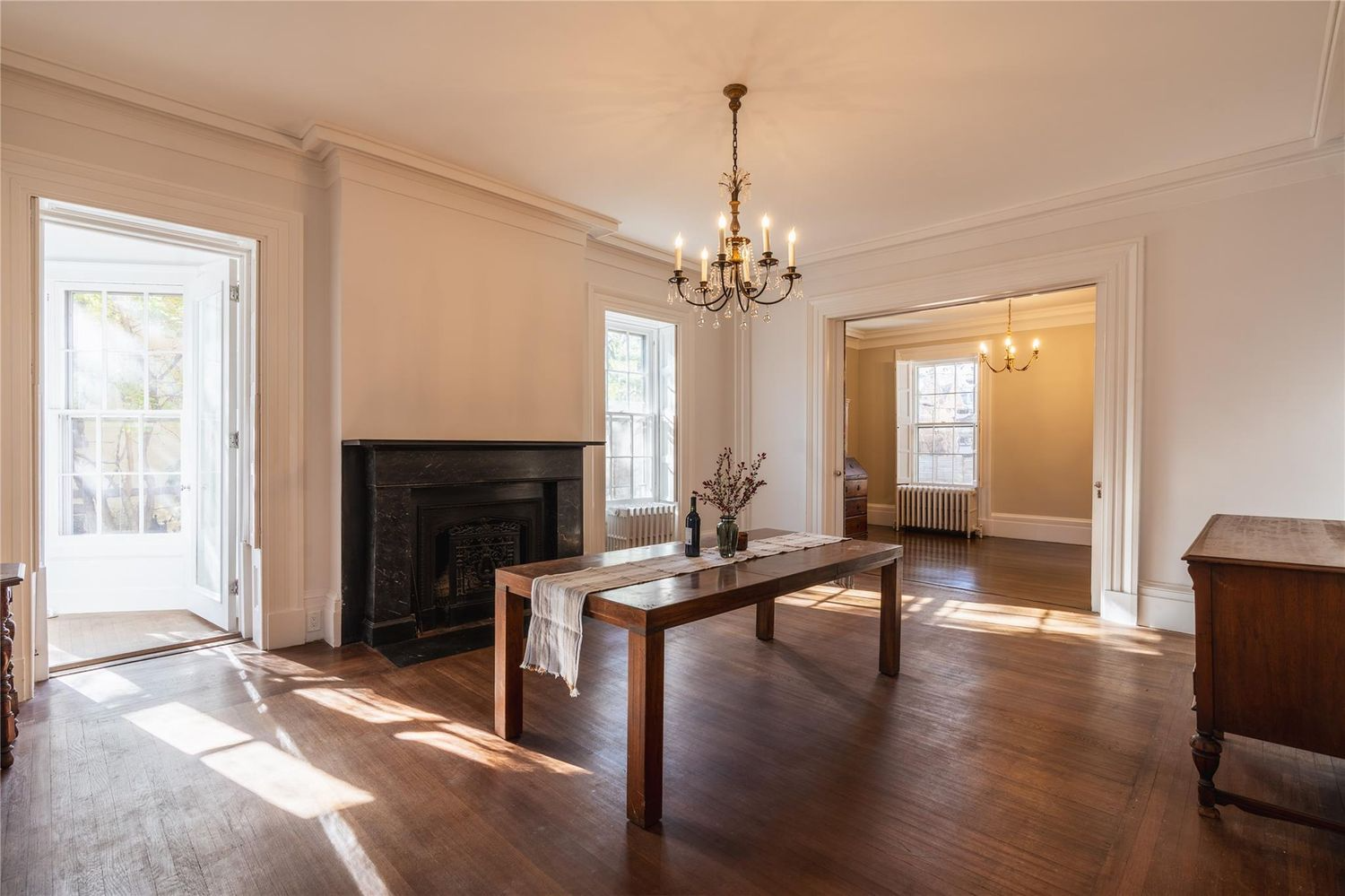 dining room with marble mantel, wood floor