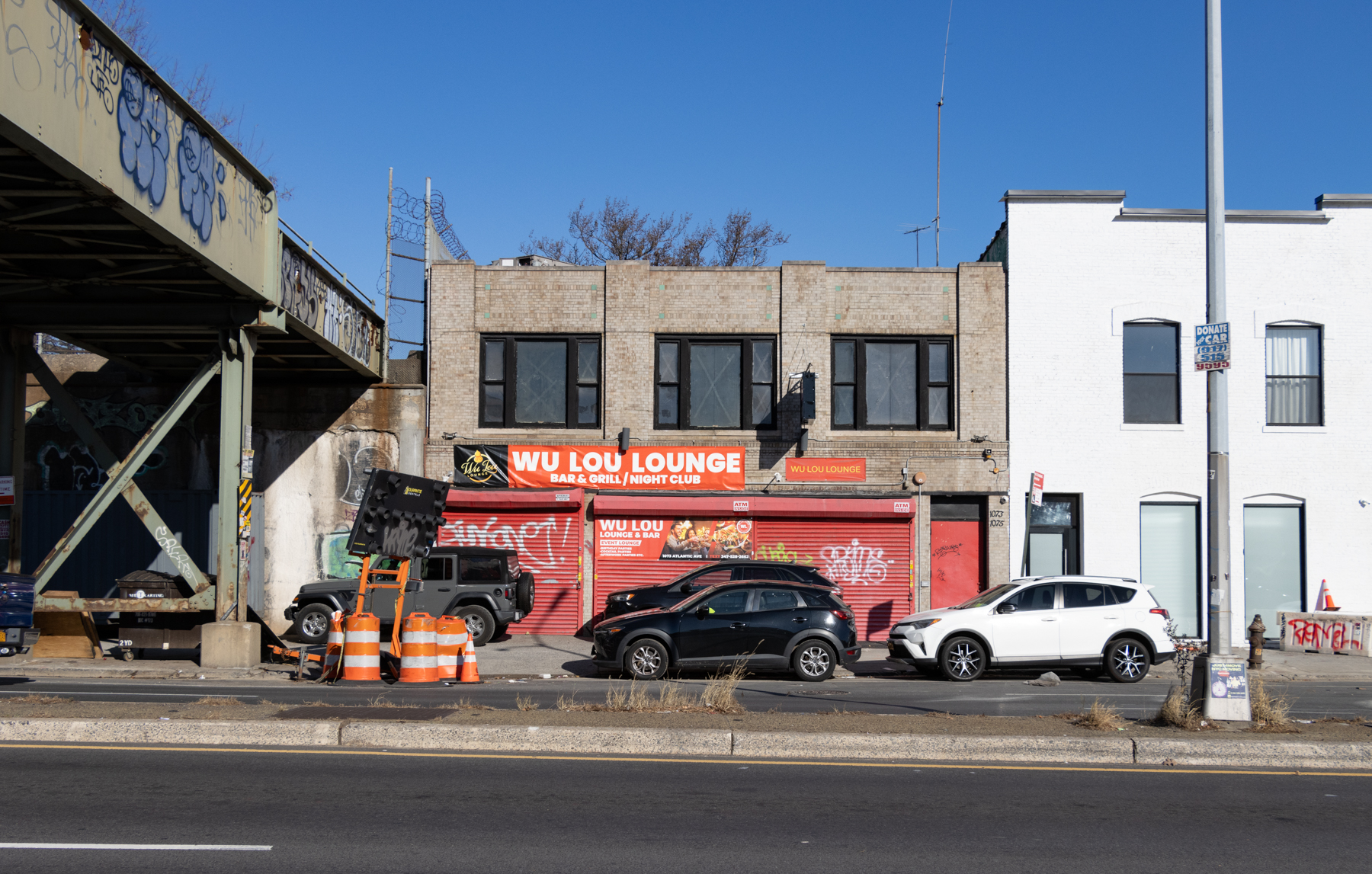 low scale brick building next to the elevated shuttle tracks