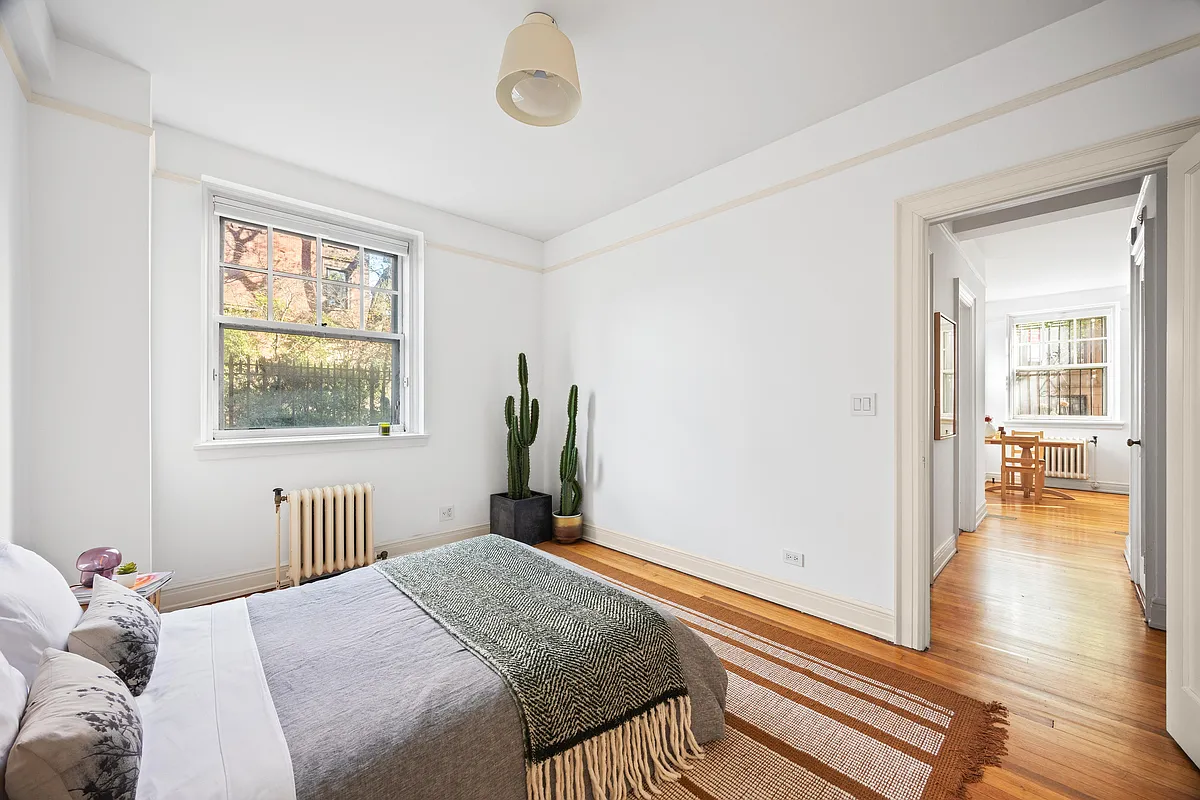 bedroom with picture rail, wood floor