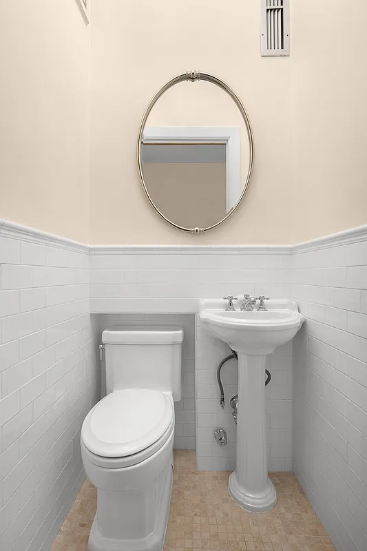 bathroom with white subway tile on walls, white fixtures