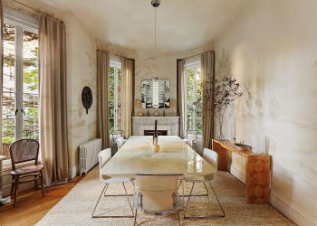 dining room with a mantel and with a scenic landscape of trees painted on the walls