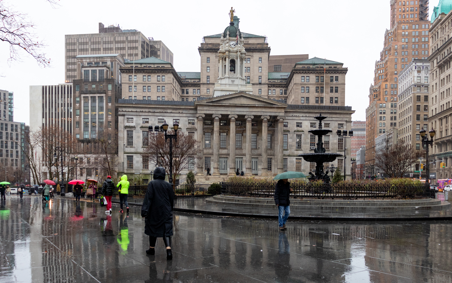 brooklyn -people walking in the rain in front of borough hall