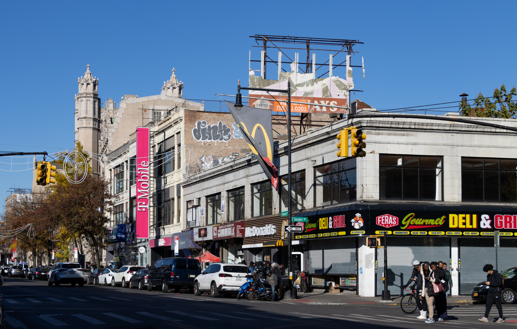 brooklyn - view on flatbush avenue with pedestrians, vehicles and, in the background, erasmus high school