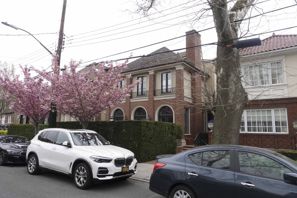 brick house behind a hedge