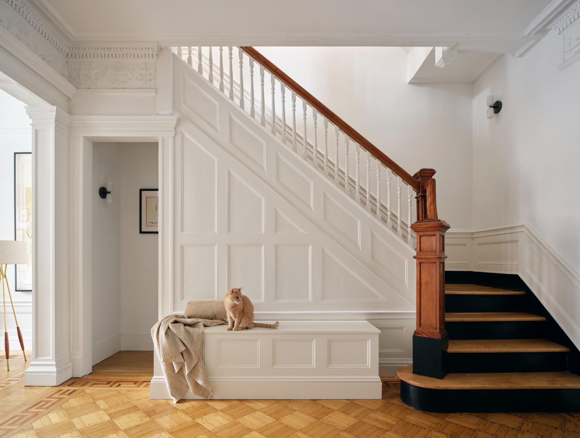 BOTTOM OF STAIRCASE WITH WAINSCOTING