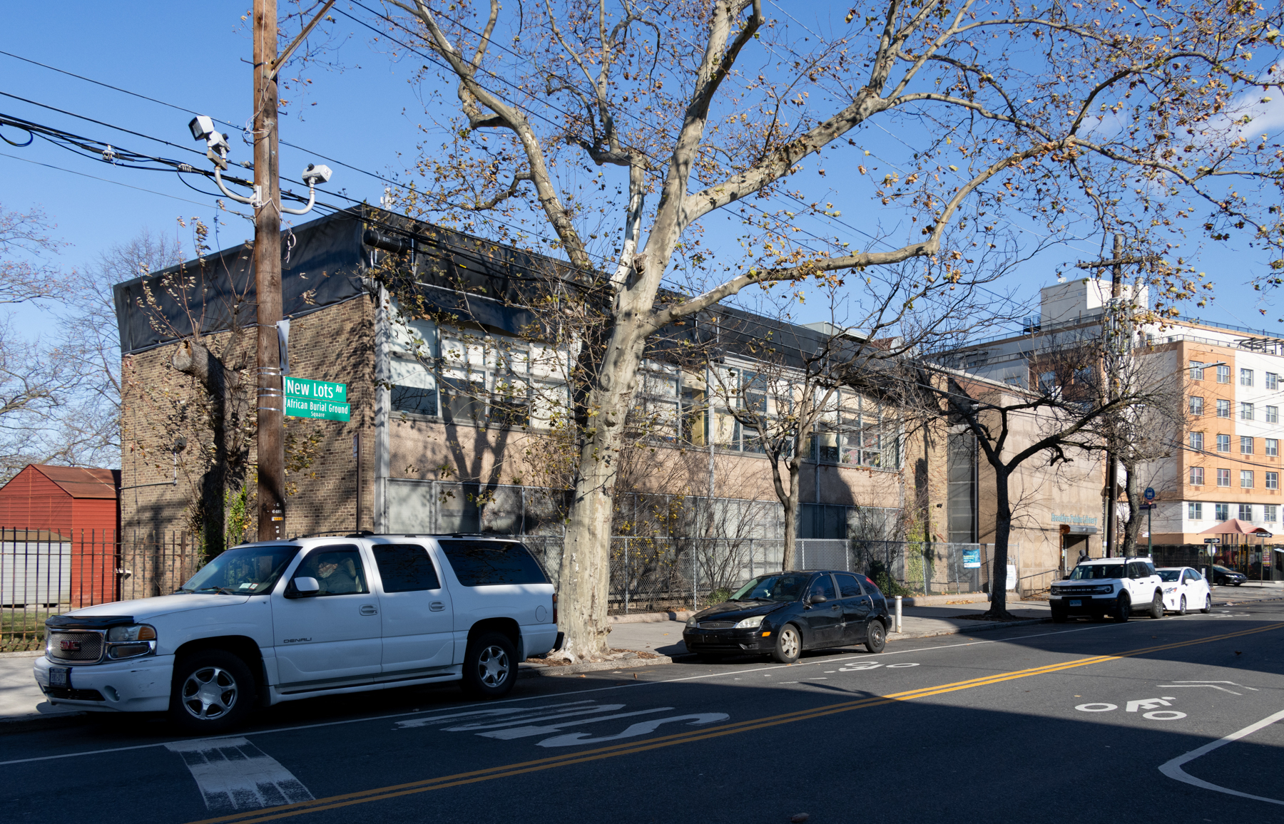 view of new lots library from corner of schenck and new lots avenue showing black tarp on roof