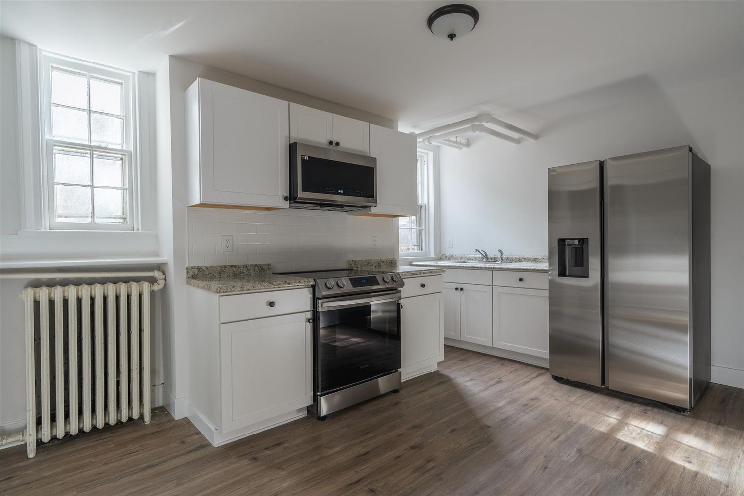 apartment kitchen with white cabinets
