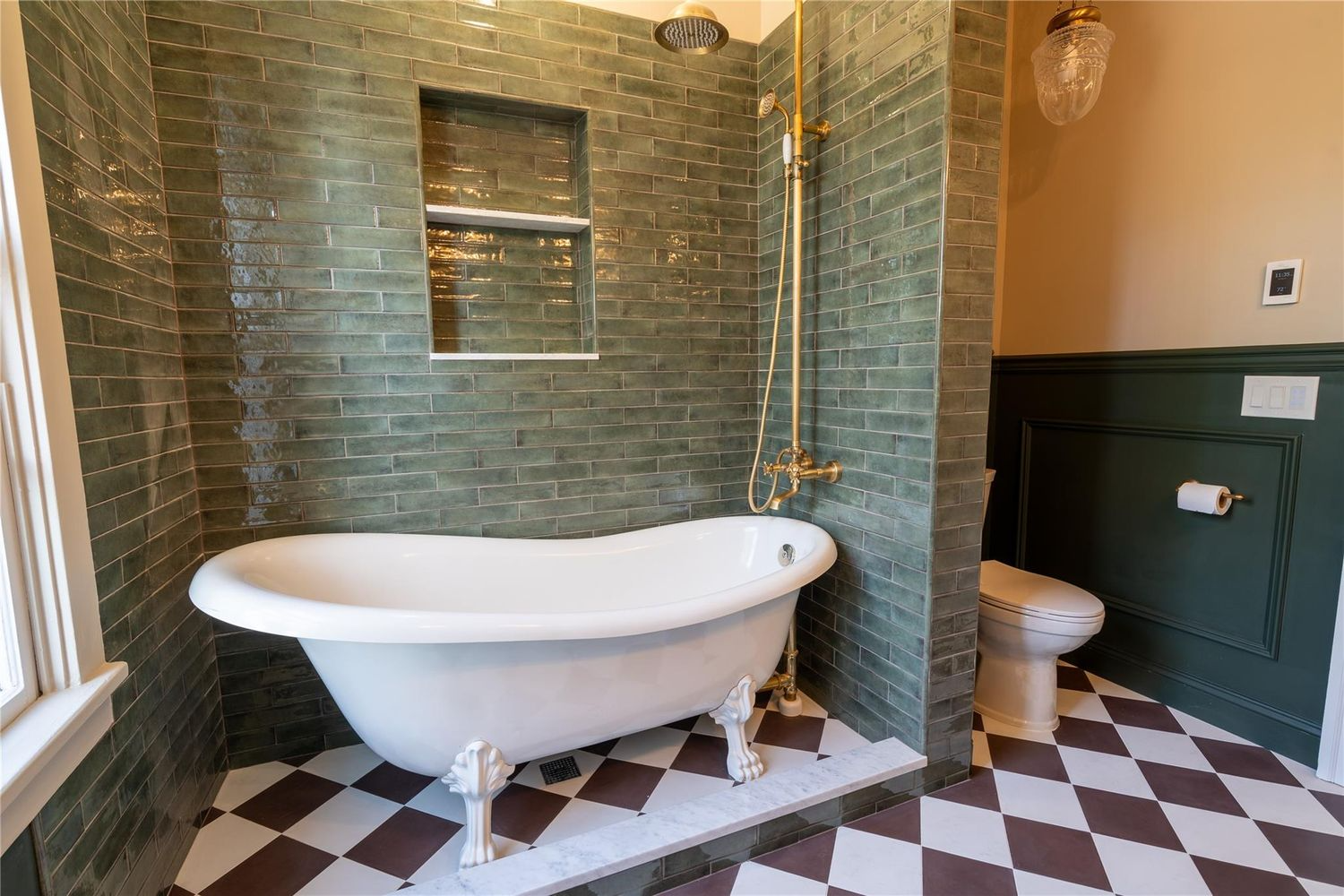 bathroom with green tile surround for tub