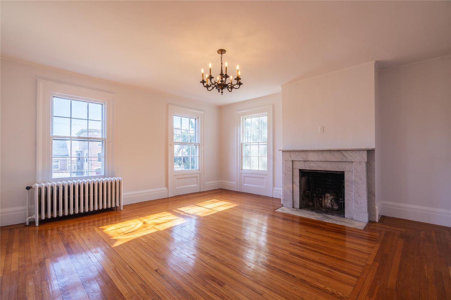 bedroom with wood floor, marble mantel, two exposure