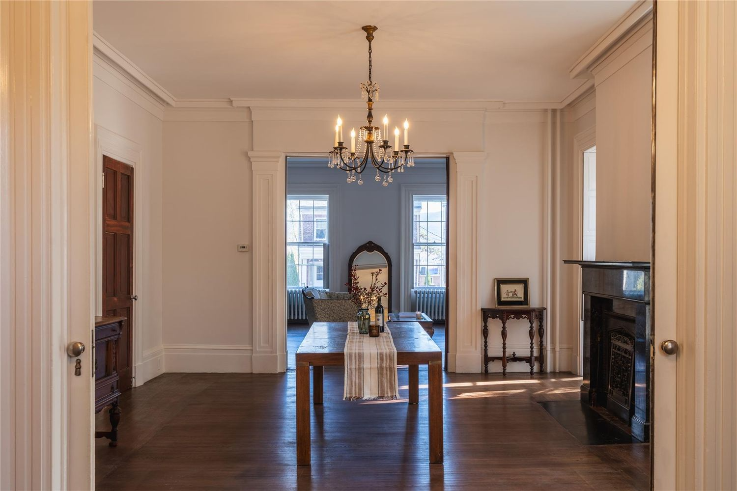 dining room with marble mantel, wood floor