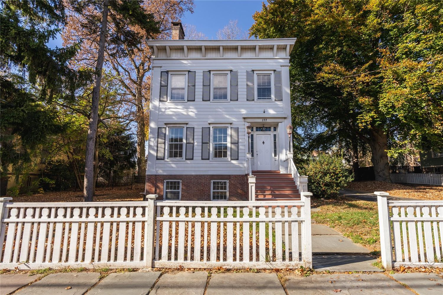 newburgh- white picket fence with clapboard house beyond
