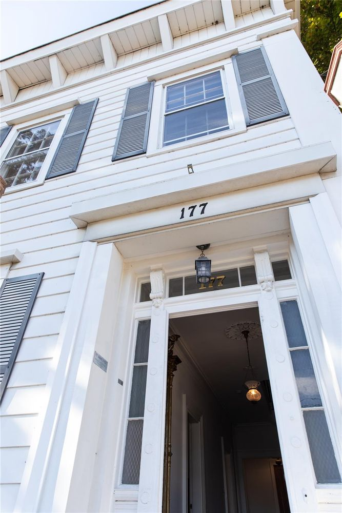 closeup of front door with 177 in black numbers