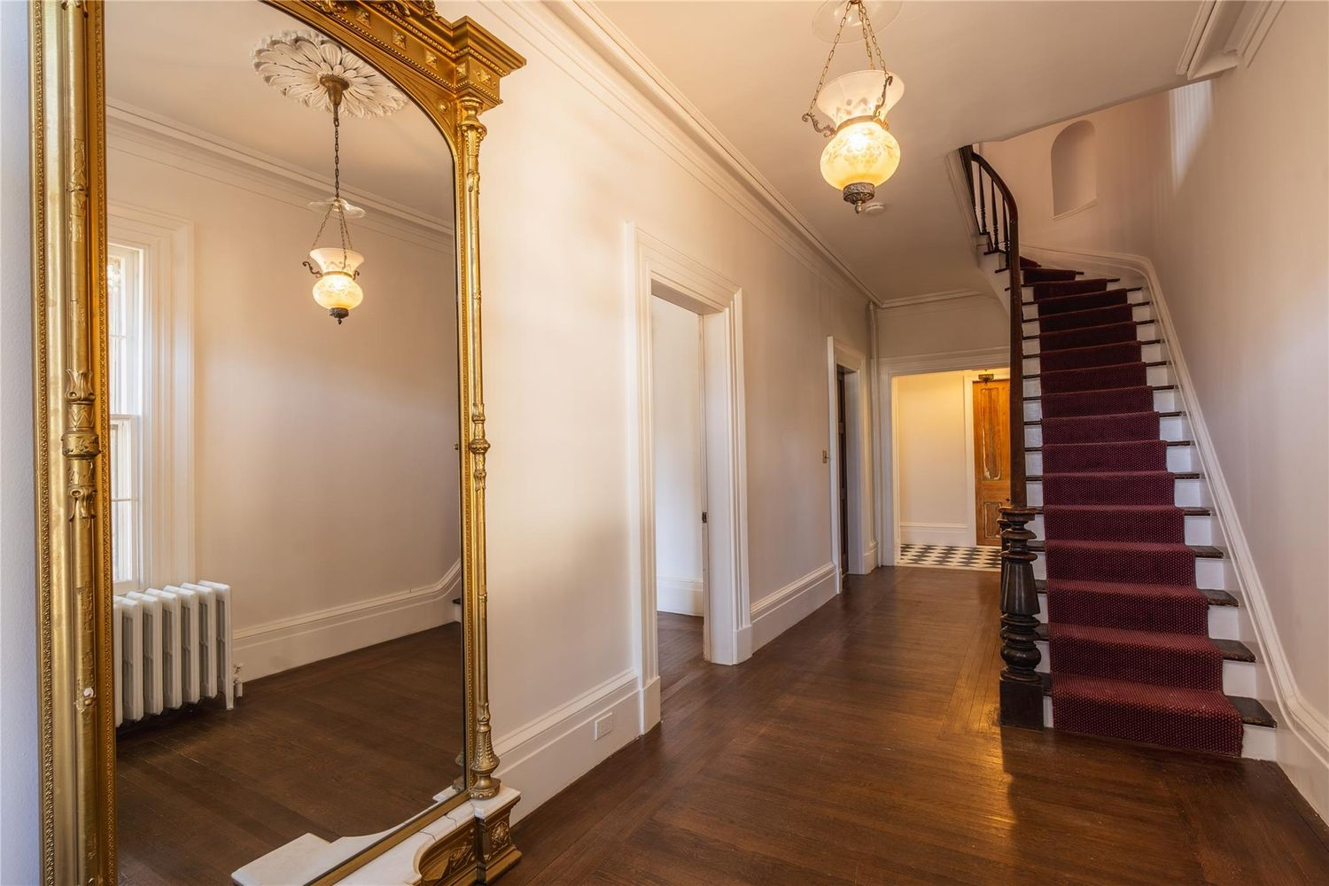 entry hall with mirror, stair with coffin corner aka stair niche