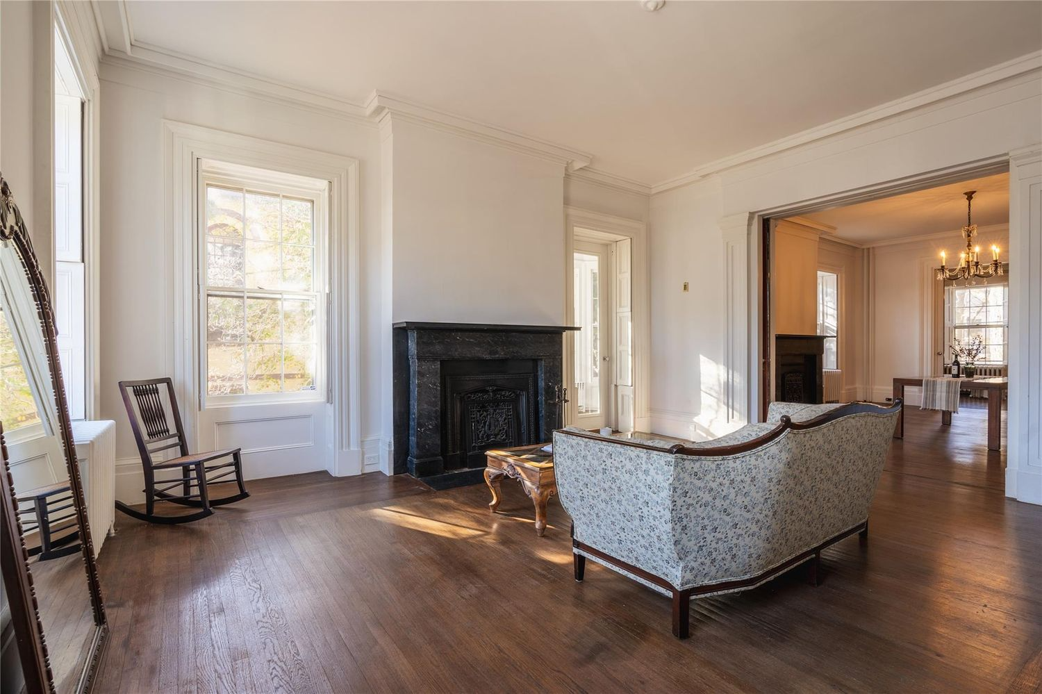 parlor with marble mantel, wood floor