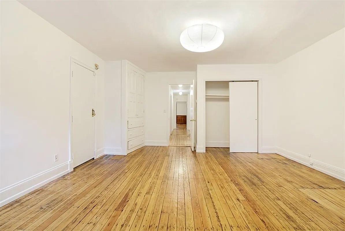 bedroom with closet, built-ins and wood floor