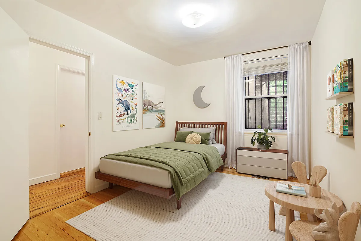 virtually staged small bedroom set up as a childrens room with twin bed and play table