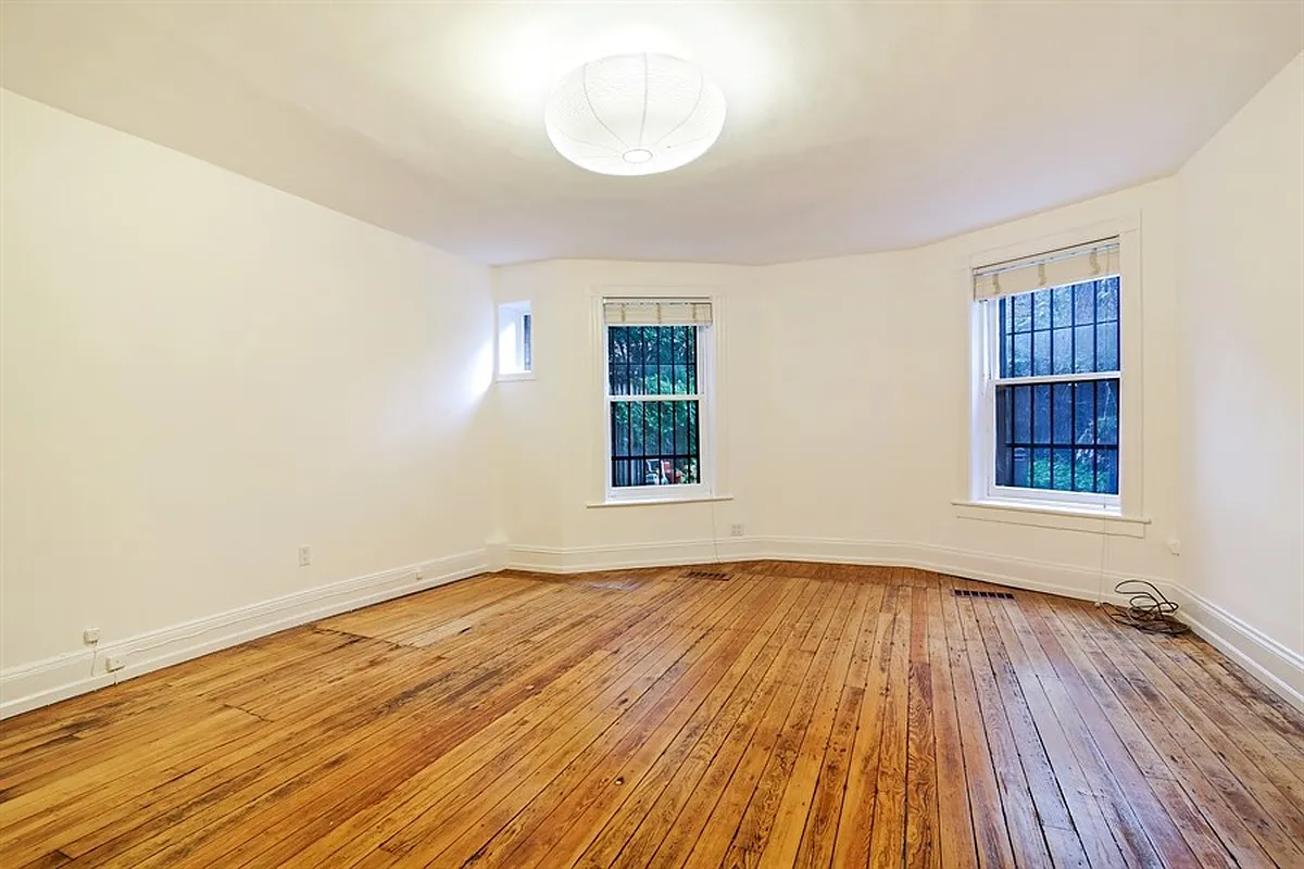 bedroom with wood floor, white walls