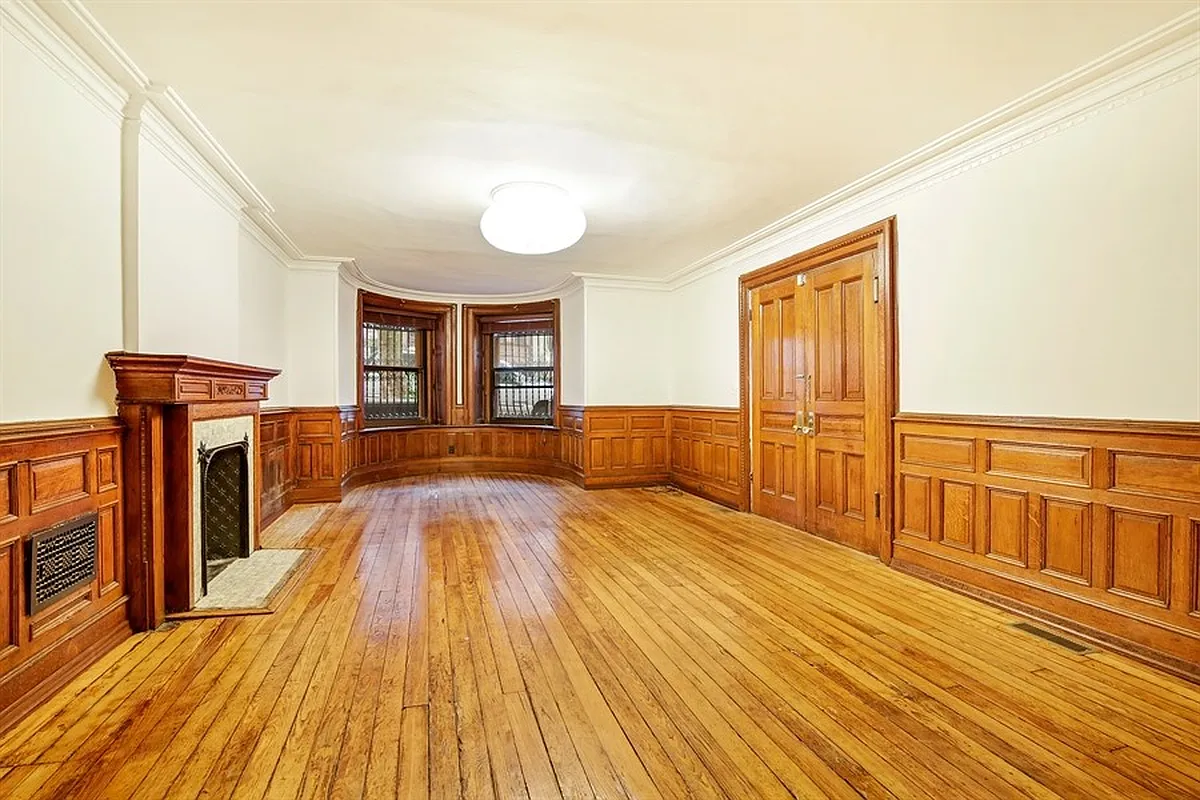 park slope - garden level living room with wood floor, mantel, wainscoting