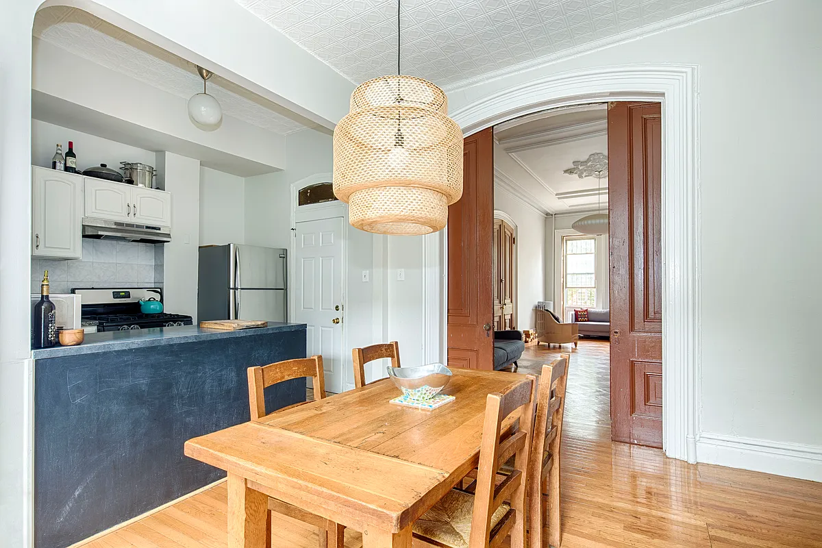 dining room with view through pocket doors to parlor