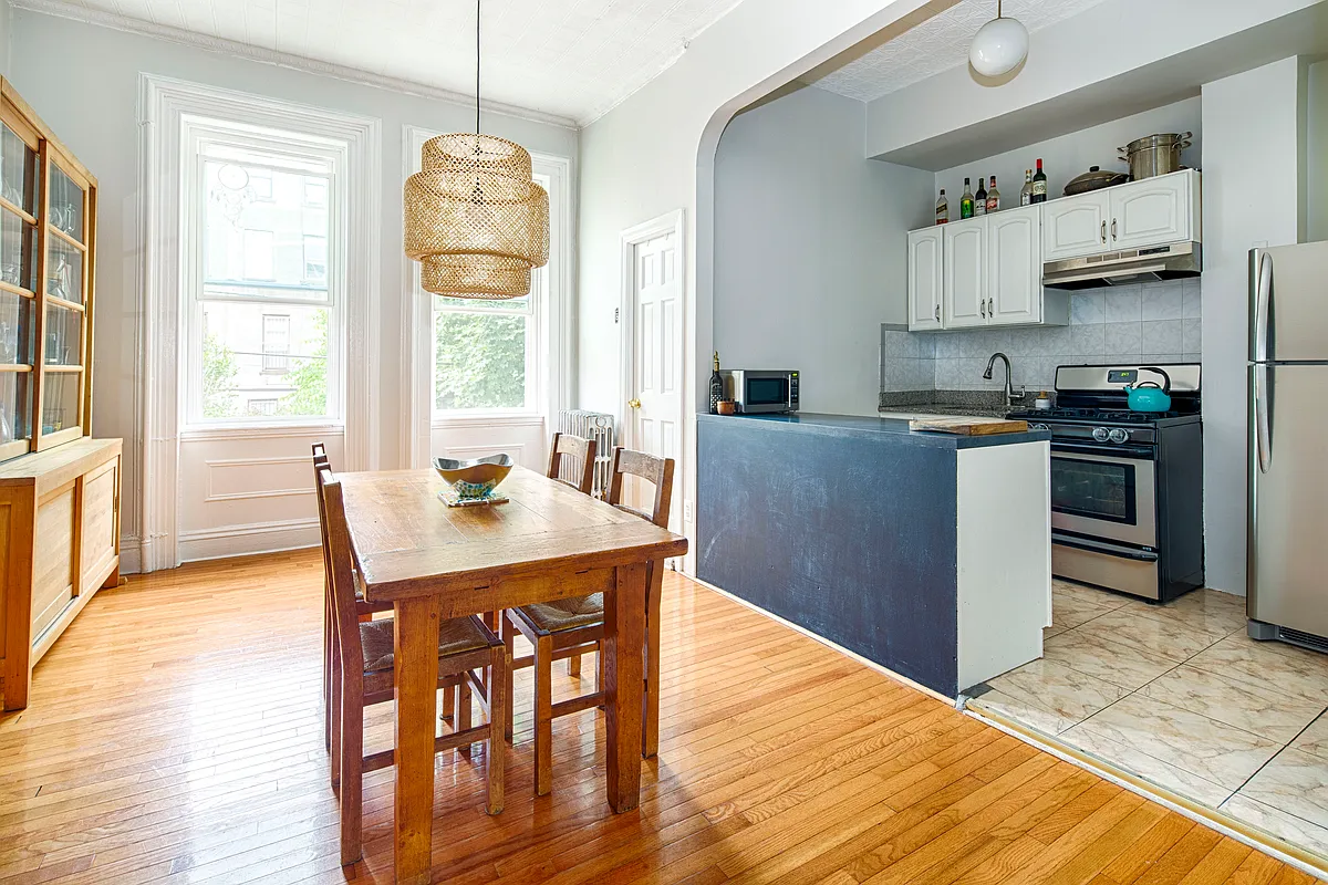 dining room with kitchen tucked into an arched alcove