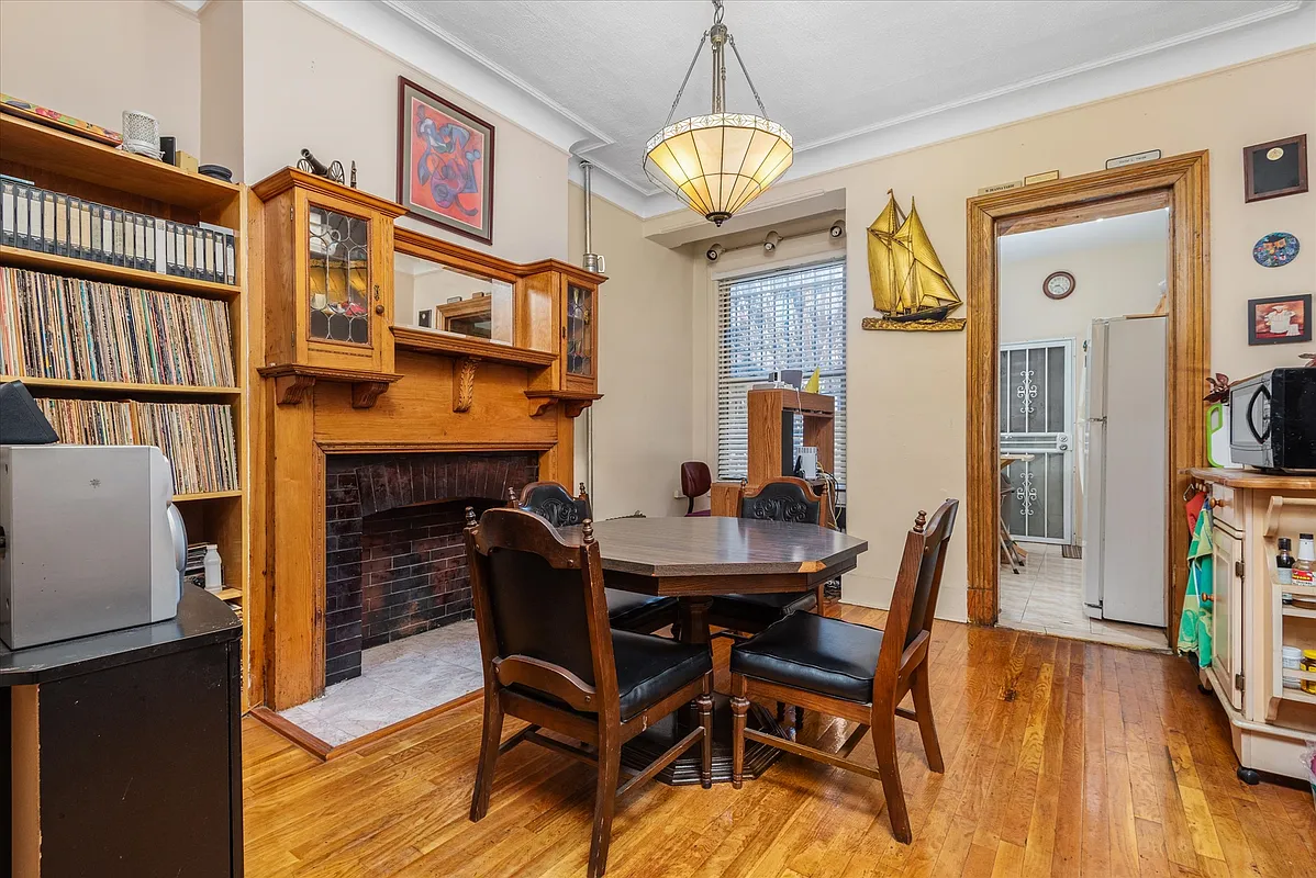 dinging room with wood mantel with leaded glass display cabinets