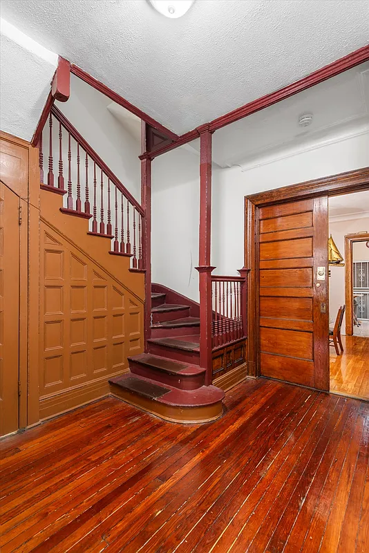 stair hall with original stair, pocket doors