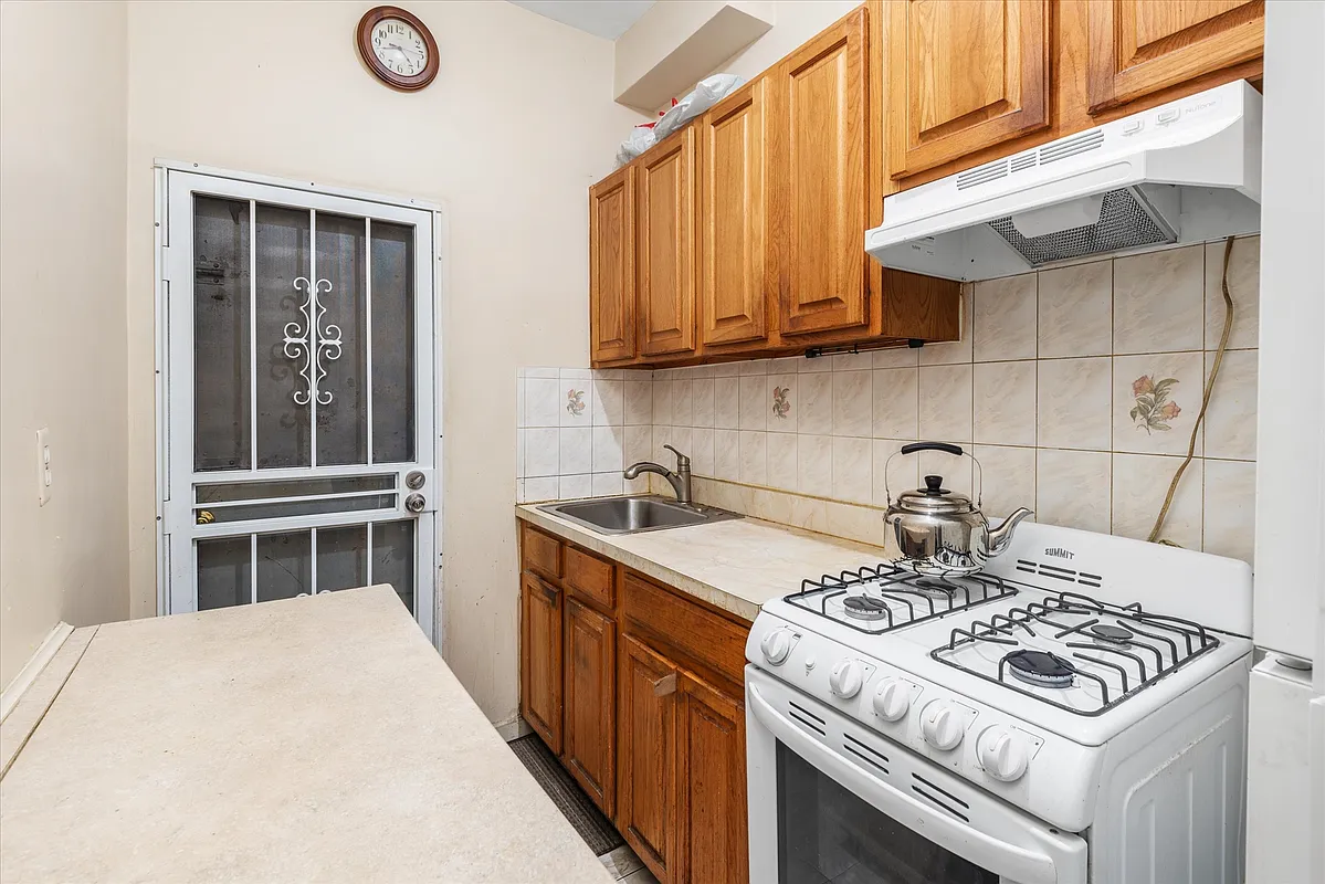 kitchen with wood cabinets, white appliances