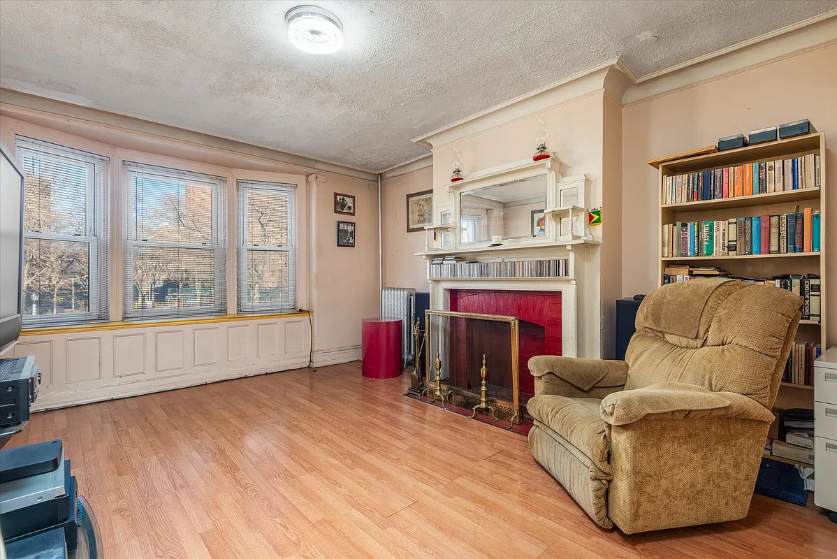 living room with mantel with display shelves, mirror