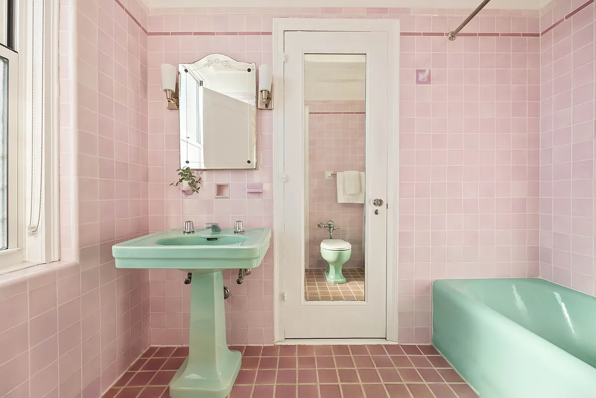 art deco bath with mauve wall and floor tile and green tub and sink