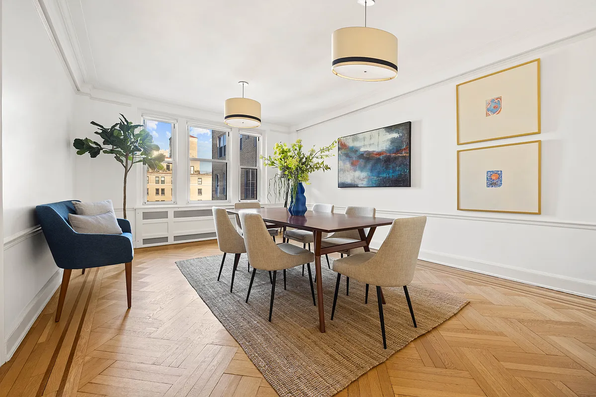 dining room with wood floor, chair rail, white walls