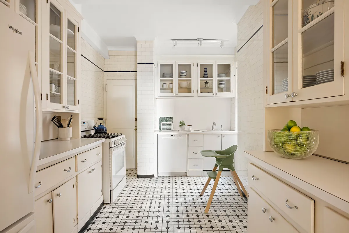 kitchen with black and white tile floor and white subway tile on the walls