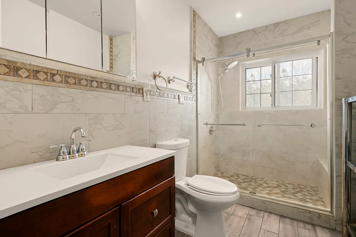 bathroom with shower, beige tile