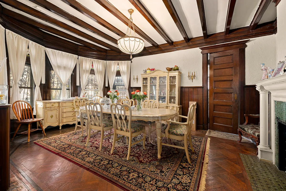 dinign room with beamed ceiling, bay window, stained glass, mantel