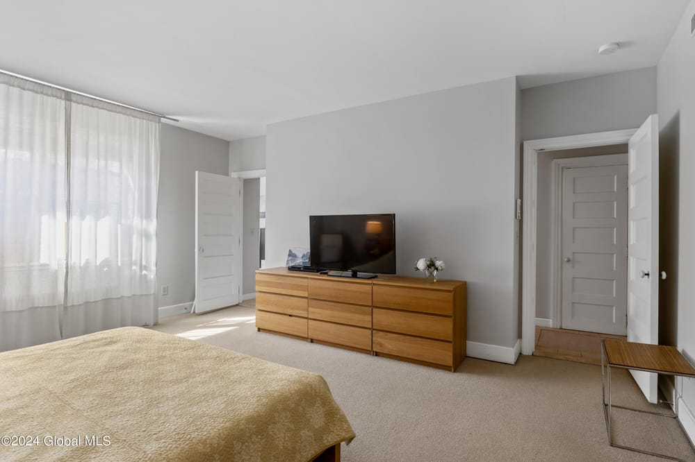 bedroom with beige carpet
