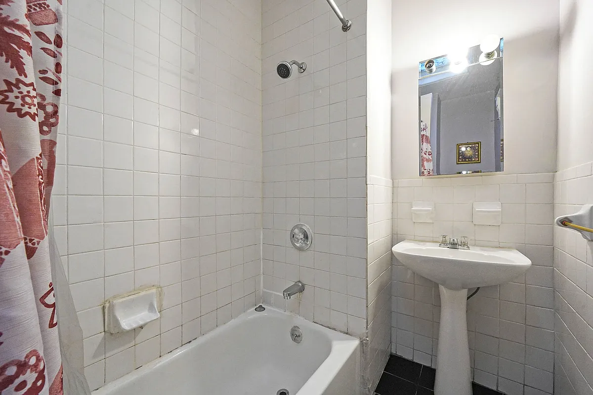 bathroom with white tile and fixtures